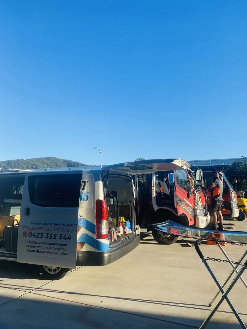 The Budget Auto Glass van parked beside a truck having its windscreen replaced